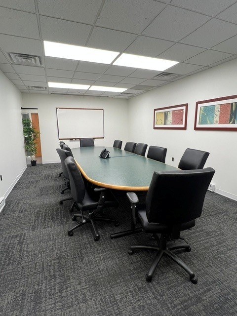The large conference room with a long table and seating for twelve