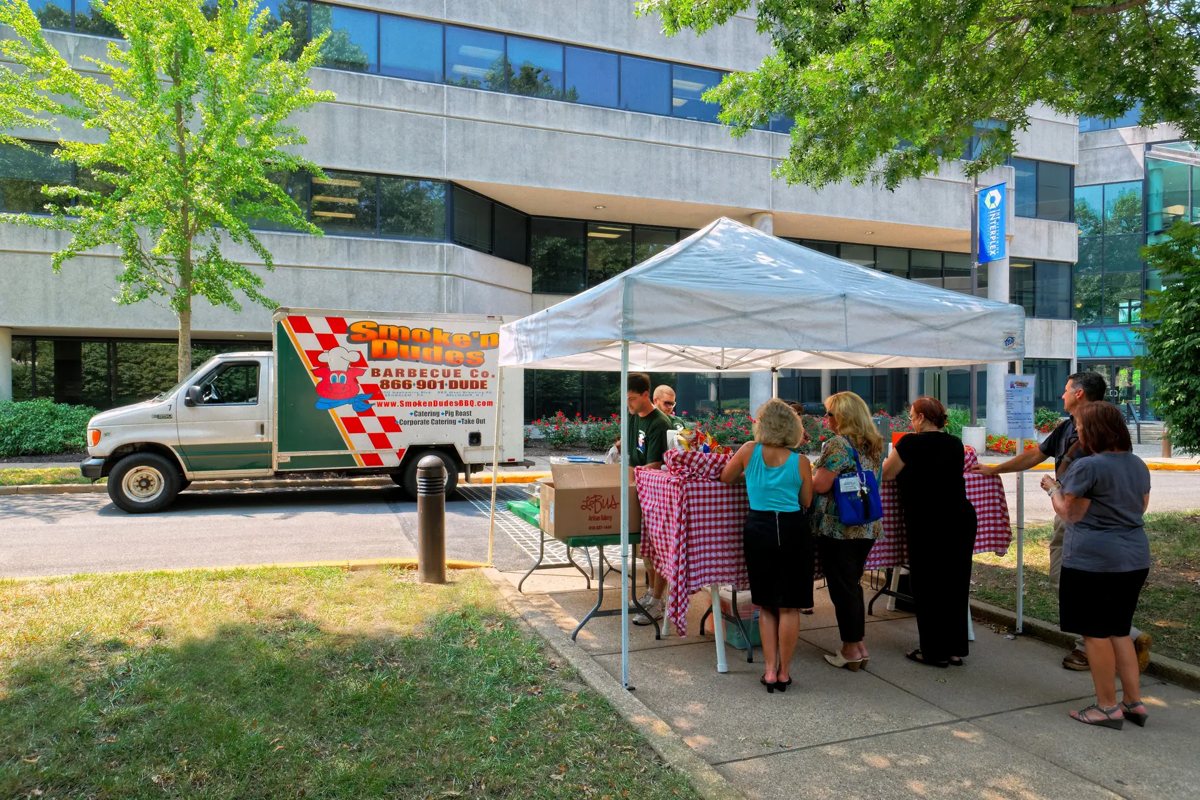 Tenants at a barbecue lunch event outside an Interplex building