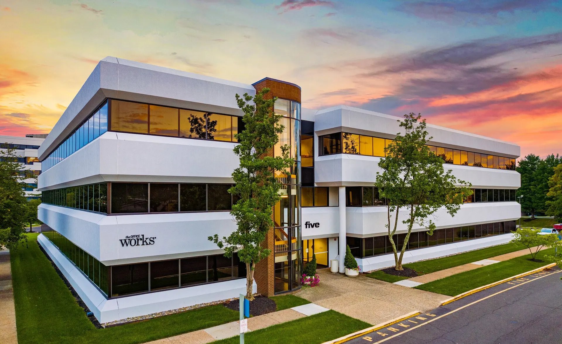 Neshaminy Interplex Building Five at dusk, with The Office Works signage on the facade